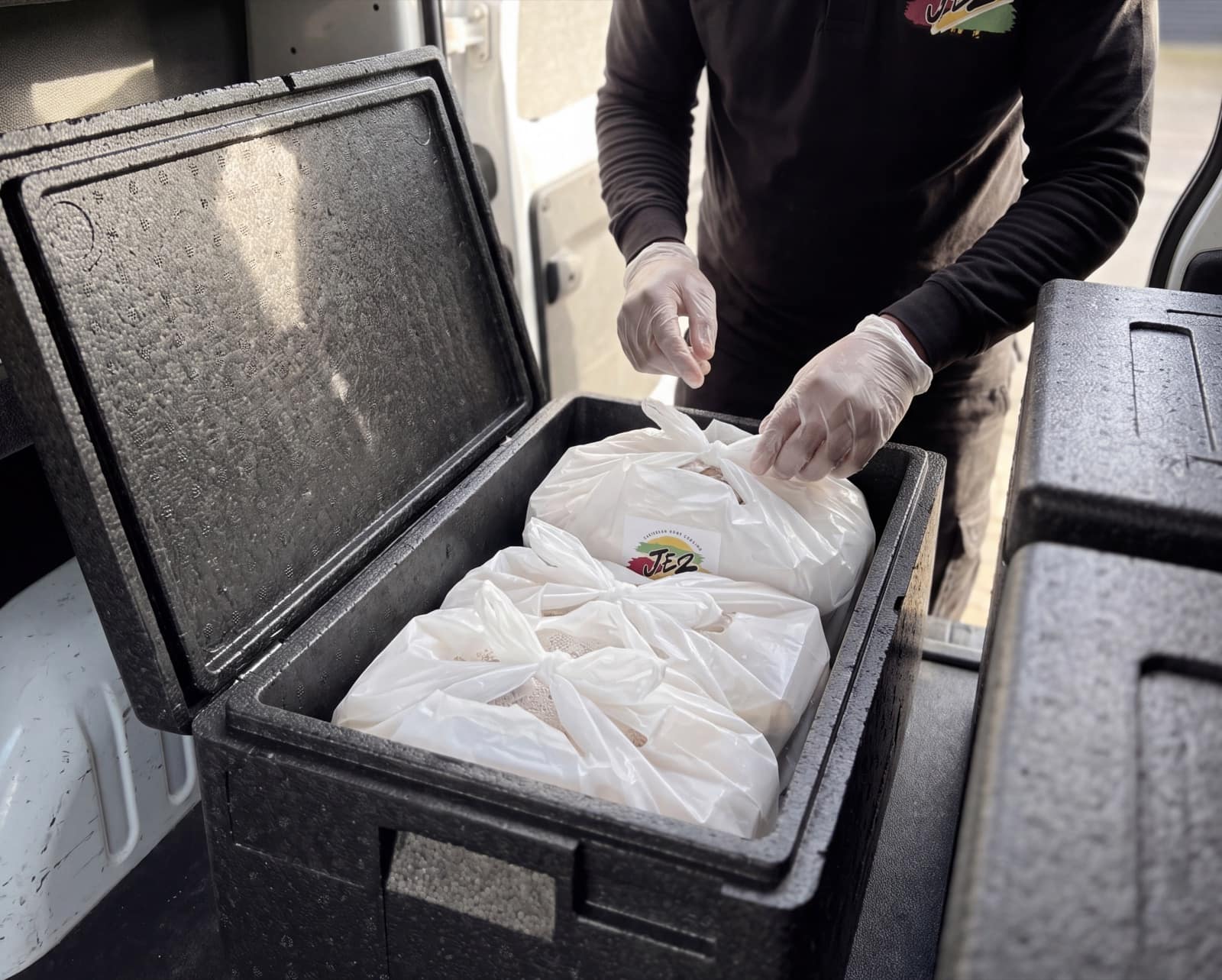 Jez team member loading customer orders into professional insulated delivery boxes
